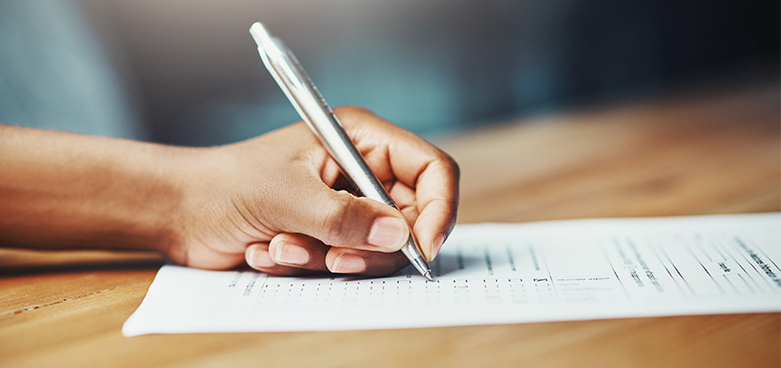 a hand holding a pen