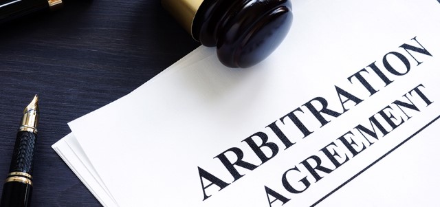  Arbitration agreement and gavel on a desk