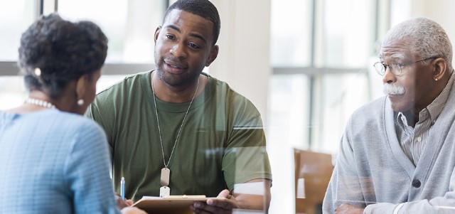 Father observes as army soldier son discusses loan