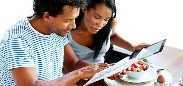 Two people looking at a financial document