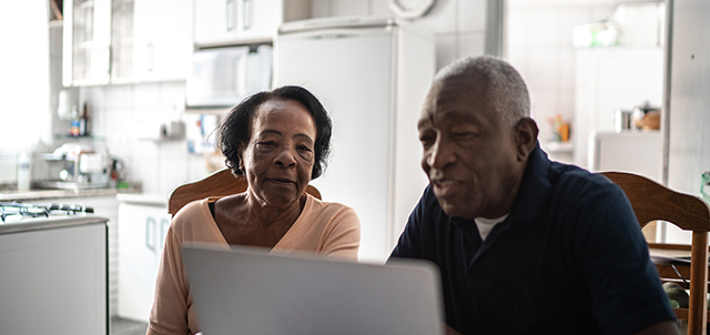 Two people looking at a laptop