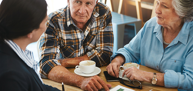 A couple sitting at a table with a financial advisor