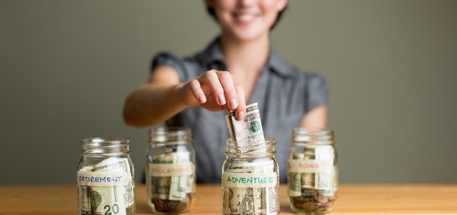 Woman saving in jars